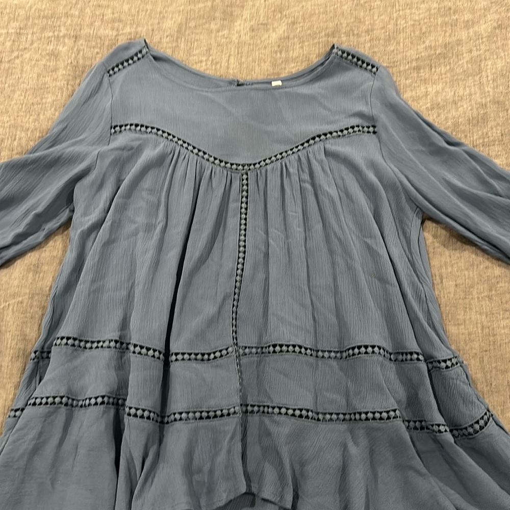 Dusty sky blue blouse, size medium. Peekaboo detail where you see the trim.